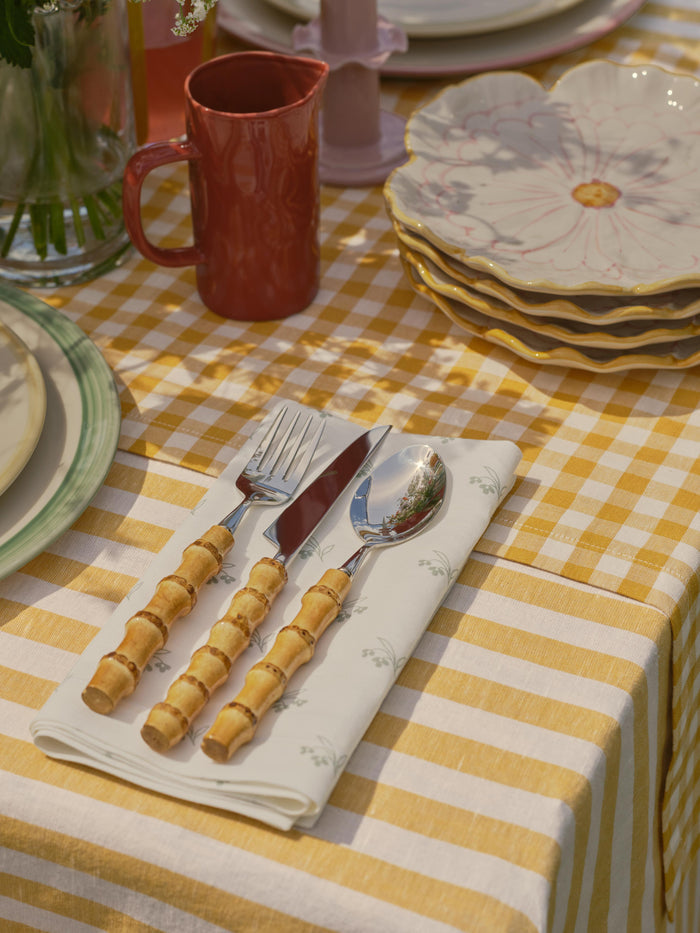 Table setting with cutlery on a checkered tablecloth