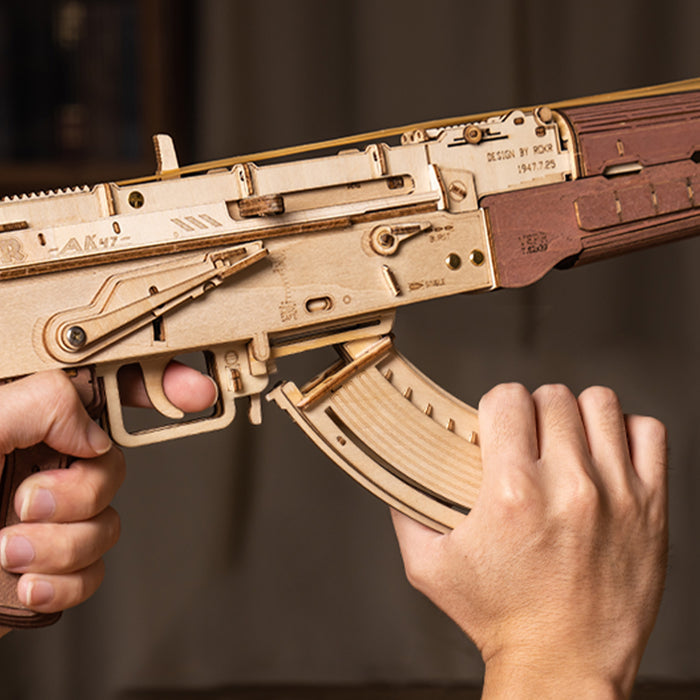ROKR AK-47 Assault Rifle LQ901 wooden puzzle close-up showing the trigger assembly, engraved receiver body and dark walnut-tone grip detail