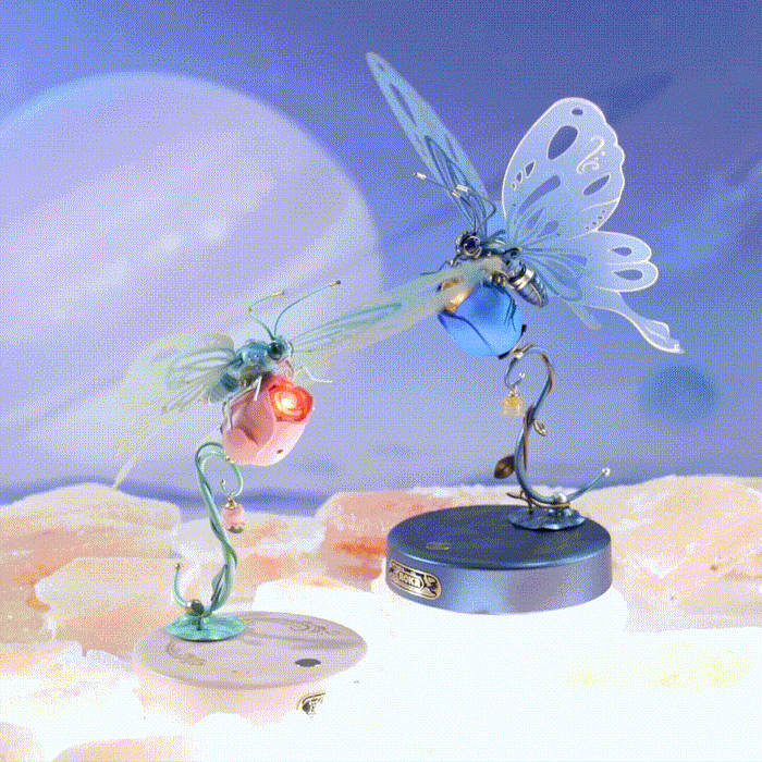ROKR Butterfly mechanical puzzle set showing pink and blue variants side by side on a dreamy cosmic landscape background