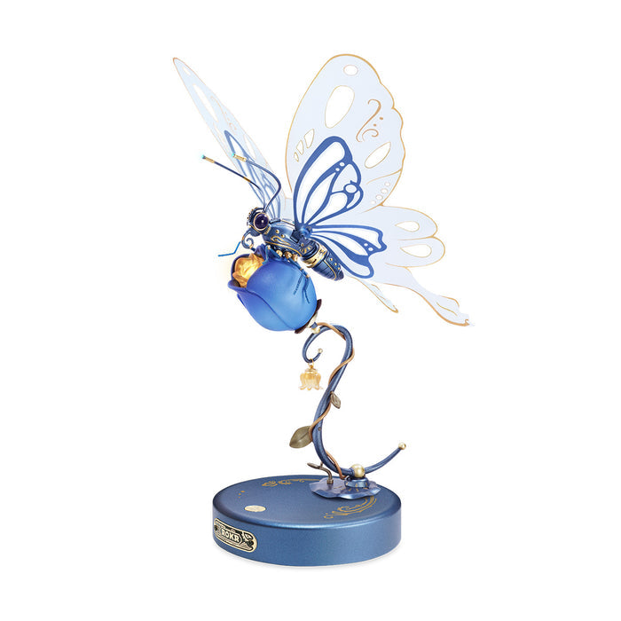 ROKR Butterfly mechanical 3D wooden puzzle in blue and white tones, holding a blue flower bud on a dark circular base