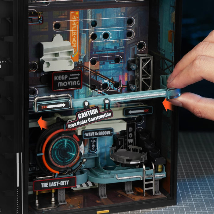 Hand adjusts the lower rail mechanism on the ROKR Last City marble run cabinet.