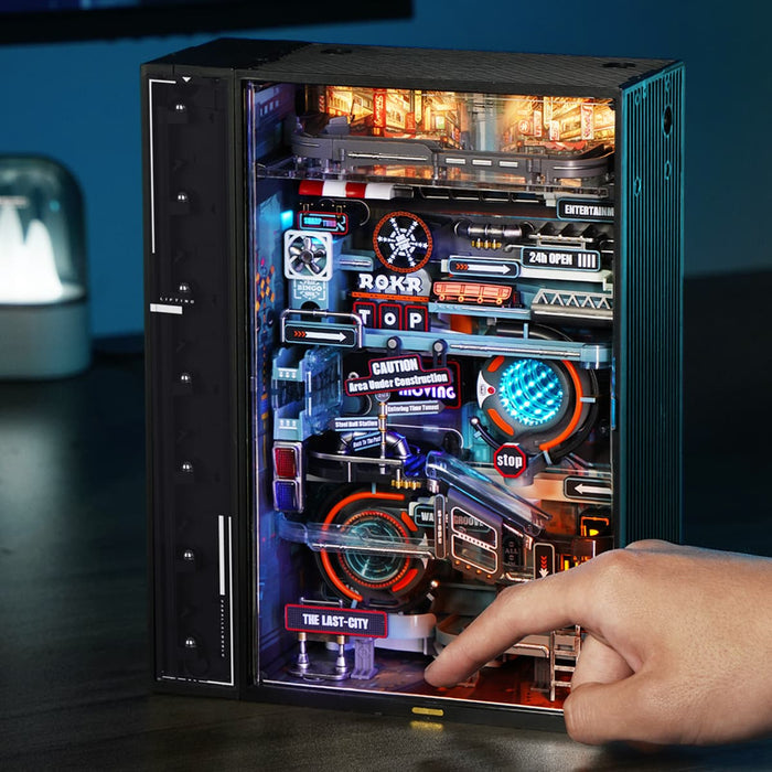 Finger presses the lower control area of the ROKR Last City marble run cabinet.