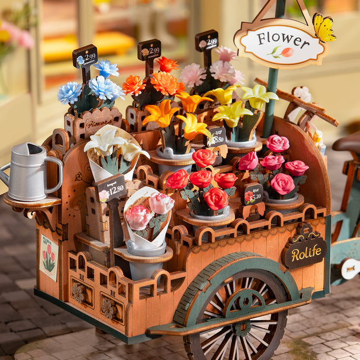 Rolife Blossom Cart detail view showing red and yellow tulips with handwritten price tags and potted plants on the cart