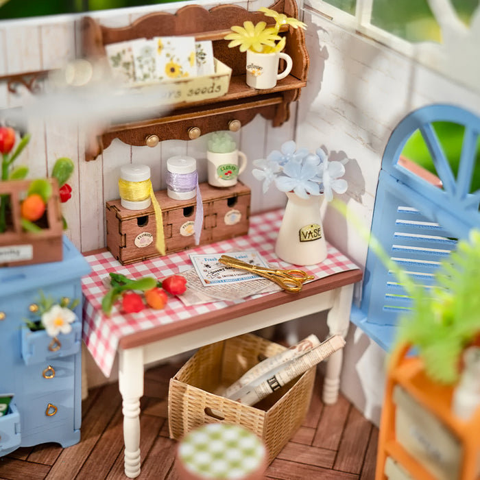 Rolife miniature kitchen scene close up showing wooden table with strawberries, glass jars and yellow flowers